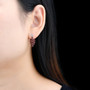 red garnet and zircon cluster drop earrings in rhodium over sterling silver worn on the ear