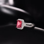 pink tourmaline and diamond emerald cut halo ring in 14k white gold shown in a lifestyle photo