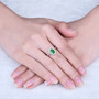 tsavorite garnet and diamond halo 14k white gold ring on hand model