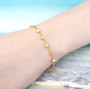 opal and zircon round station 18k yellow gold over sterling silver bracelet worn on a wrist