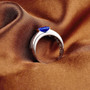 close up of mens tanzanite half bezel and diamond 14k white gold ring