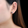 multi gemstone oval cluster earrings in rhodium over sterling silver worn on the ear