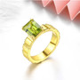 peridot and emerald cut solitaire 18k yellow gold over sterling silver ring shown in a lifestyle photo