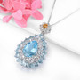 side view of sky blue topaz white topaz and citrine pendant necklace in rhodium over sterling silver