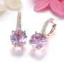 side view of rose de france amethyst and white zircon dangle earrings in 18k rose gold over sterling silver