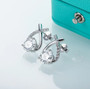 close up of moissanite half infinity drop earrings in 18k white gold over sterling silver