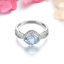 front view of aquamarine and white zircon cushion halo ring in rhodium over sterling silver