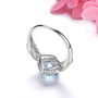 full view of aquamarine and white zircon cushion halo ring in rhodium over sterling silver