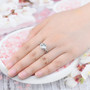 aquamarine and white zircon cushion halo ring in rhodium over sterling silver worn on a hand