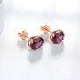 close up of rhodolite garnet 8x6mm oval stud earrings in 14k rose gold