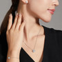moissanite brilliance round halo stud earrings in rhodium over sterling silver worn on the ear