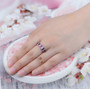 rhodolite garnet white topaz and emerald baguette band ring in rhodium over sterling silver worn on a hand