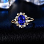 tanzanite and diamond halo 14k yellow gold ring shown in a lifestyle photo