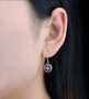 rhodolite garnet and white zircon dangle earrings in rhodium over sterling silver worn on the ear