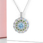 sky blue topaz opal chrome diopside and zircon cluster pendant necklace in rhodium over sterling silver shown in a lifestyle photo