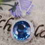 swiss blue topaz and diamond oval double halo 18k white gold necklace shown in a lifestyle photo