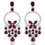 elegant garnet and white zircon articulating earrings in rhodium over sterling silver