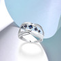 blue sapphire and diamond open work 14k white gold band ring shown in a lifestyle photo
