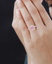 natural morganite wedding ring with pink and white diamond halo in solid 14k rose gold worn on a hand