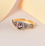color change garnet three stone and white zircon halo ring in 18k yellow gold over sterling silver shown in a lifestyle photo