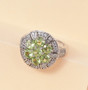 natural peridot and white zircon cluster ring in rhodium over sterling silver shown in a lifestyle photo