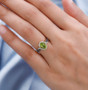 peridot with brown and white zircon ring in 18k yellow gold over sterling silver worn on a hand