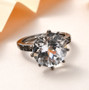 natural white topaz round solitaire ring in black rhodium over sterling silver shown in a lifestyle photo