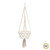 Een macrame hangmand in het wit met onderaan een grote tassel.