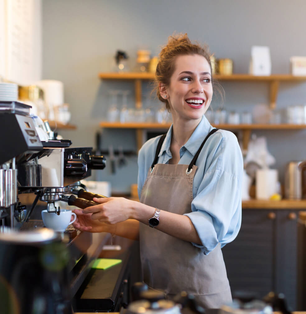 Woman making a beverage at a cafe