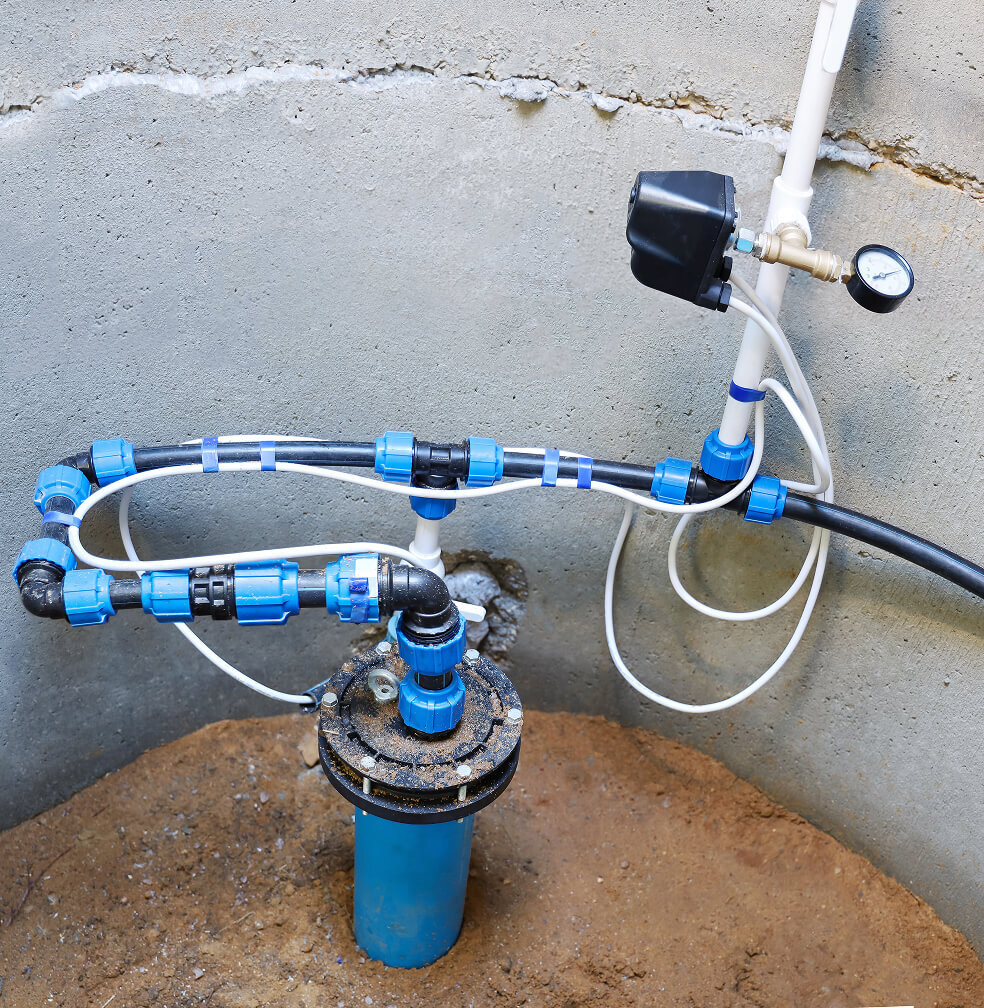 A water pump system assembled inside an empty well.