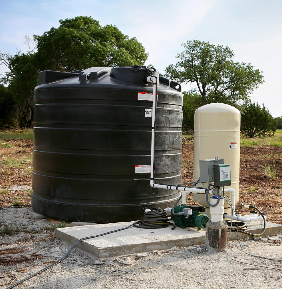 A well with a pressure switch and a storage tank.