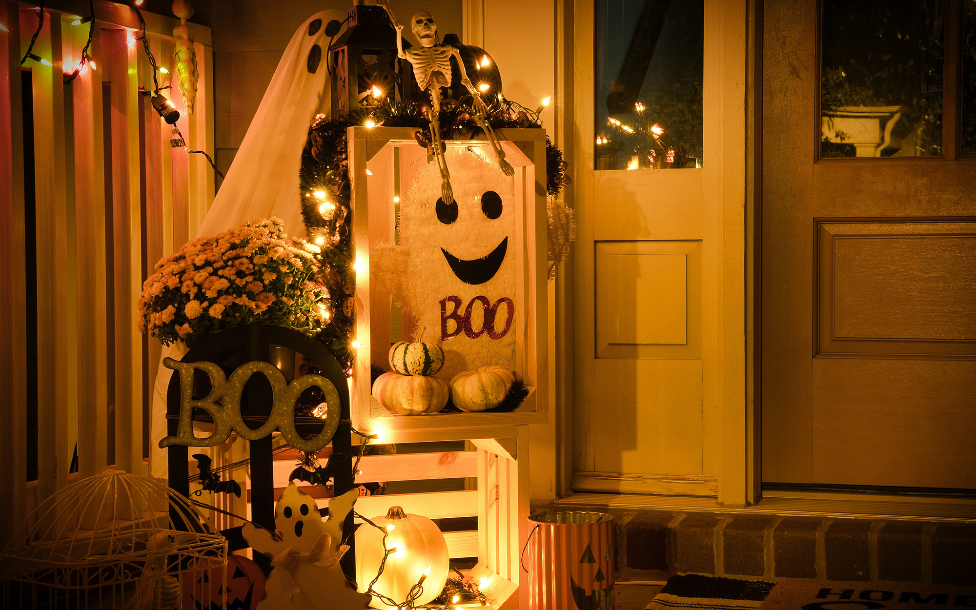 Halloween decorations on lighted door step