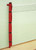 Wall mounted volleyball post fixed to a wall inside sports hall with protection pad