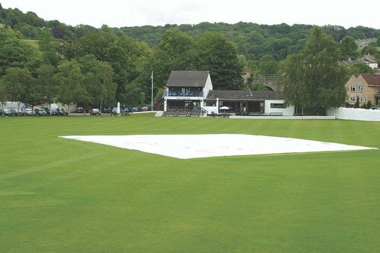 Lay flat rain cover over cricket wicket