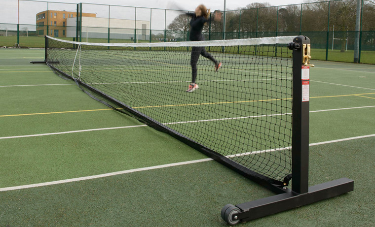 Wheelaway Freestanding Tennis Posts in use at an outdoor tennis court