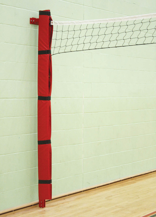 Wall mounted volleyball post fixed to a wall inside sports hall with protection pad