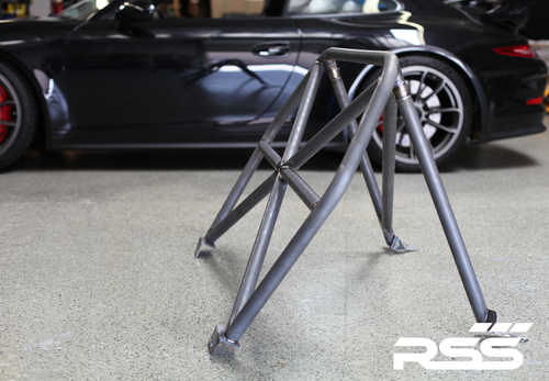 RSS 940-XC Series 4pt. Roll Bar (991 GT3 / RS & 991 Without Sunroof/Moonroof)

o The RSS 940-XC Series 4pt. Roll Bar features the “X-Cross” main hoop design providing superior occupant protection

o The XC’s one piece Main Hoop mounts to a reinforced chassis cross member at the B Pillar which runs the full width of the vehicle. Unlike other designs, the Main Hoop has a maximum of four bends featuring a Straight Top Tube Section forming a stronger more rigid main hoop.

o The 940-XC is a safety inspired design which mounts shoulder harnesses directly behind the occupants attaching at the main hoop horizontal bar. The main hoop mounting position greatly enhances safety by reducing the effects of “Harness Stretch.” Harness Stretch is a serious safety concern commonly overlooked with other designs.

What is Harness Stretch? Simply put, safety harness-belts allow a certain percentage of stretch during a rapid deceleration event, the longer the harness-belt, the more overall stretch it will allow. This unsafe forward movement can be dangerous, especially when airbags deploy. By significantly shortening harness-belt length (mounting to main hoop vs. rear compartment of vehicle) occupant torsos are securely anchored against the seats reducing this unwanted excessive forward movement.

o Rear Down Tubes feature precision cut and reinforced mounting plates that attach to rear shock towers incorporating all three shock mounting points, maximizing contact area to evenly distribute load.

o The Rear Diagonal Brace provides additional main hoop and rear shock tower triangulation and increases chassis rigidity.

o The 940-XC allows full seat base travel with standard seats, OE buckets or racing buckets and allows full use of factory seat belts. (Easily fits 6’4 inch driver in Recaro SPG XL Racing Seat).

o Bolt-In Installation does not require drilling of chassis or cutting of interior side panels common with other bars. The Bar uses vehicles existing hardware, carpet panel trimming is required at B and C Pillar. Professional installation is recommended for a factory installed look.

o Available in 5 Durable Powder Coat Finishes (at no additional charge): White, Silver, Satin Black, Speed Yellow, Guards Red or uncoated for custom color matching.

o Designed, Crafted, Tig Welded, and Powder Coated at the RSS Fabrication Center utilizing 1.50 inch DOM, CNC machined heavy duty locking tube couplers, and precision cut reinforced mounting plates.

o Patent Pending Design