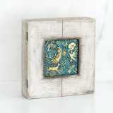 Light grey box with blue and gold scene square in the center