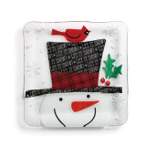 Small white square plate with snowman and top hat on it