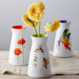 three white vases with orange, green and purple painted insides with watercolor flowers, hummingbirds and butterflies on outside