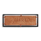 A black metal frame holding a large tan leather patch that reads "gather".