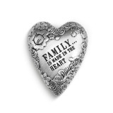 A silver art heart with a floral print and reads "Family... is made in the heart".