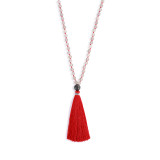 A red thread necklace with a single black bead and a red tassle.