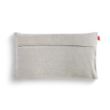 The backside of a light gray pillow with a small red tag.