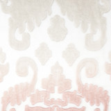 A close up view of the fabric of a cream and pink "Damask Sheer Shawl" on a white and wooden mannequin.