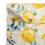 A cream button loop infinity towel with a lemon print, showing the button detail with one unbuttoned.