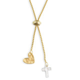 A close up image of a gold heart and silver cross pendant on a gold 2 in 1 choker necklace.