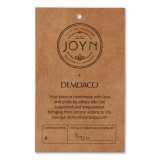Close up view of a paper packaging tag detailing information about the handmade artist of the product.