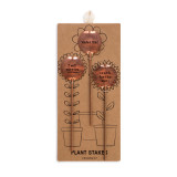 A set of three metal plant stakes attached to brown cardboard packaging.