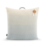 A square ombre print pillow in cream and blue with a handle at the top and a product tag attached.